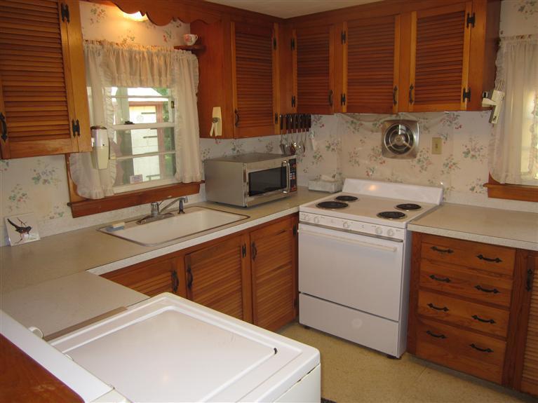 20 Skating Rink Road Hyannis, MA 02601 - Photo 11 of 20 a kitchen with cabinets appliances a sink and a counter top space