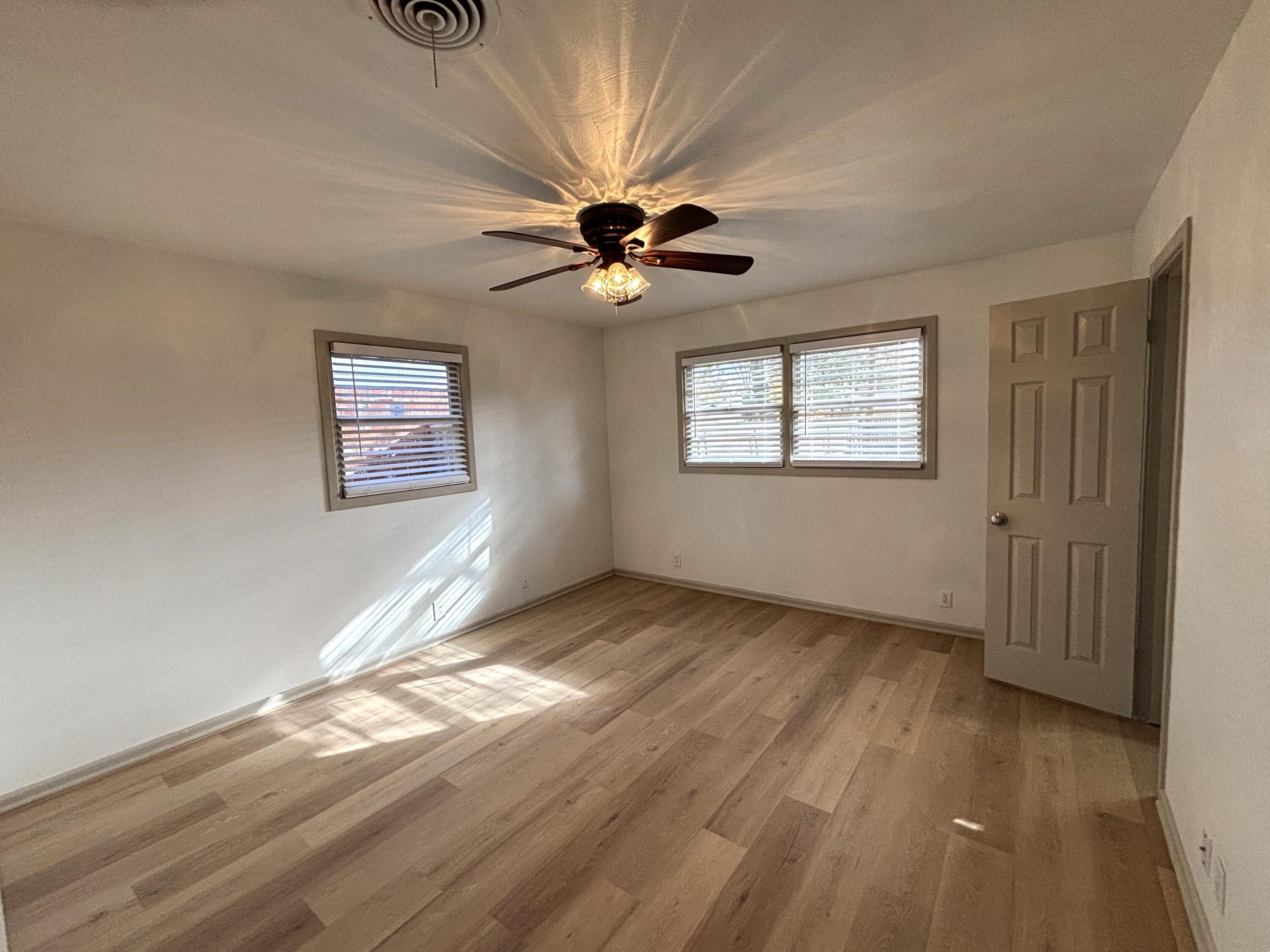 3415 58th Street Lubbock, TX 79413 - Photo 25 of 38 a view of an empty room with window and wooden floor