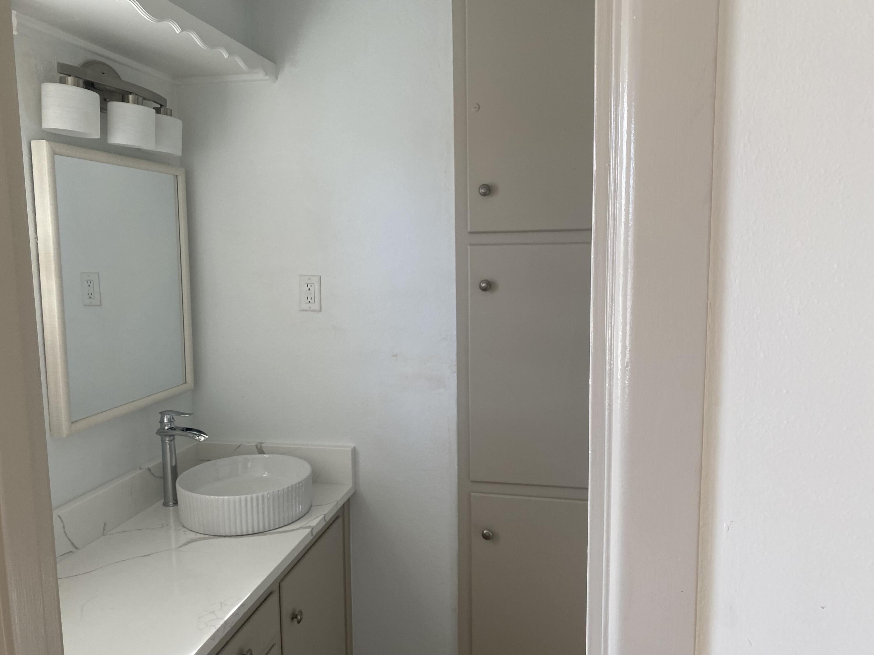 3415 58th Street Lubbock, TX 79413 - Photo 26 of 38 a bathroom with a sink and mirror