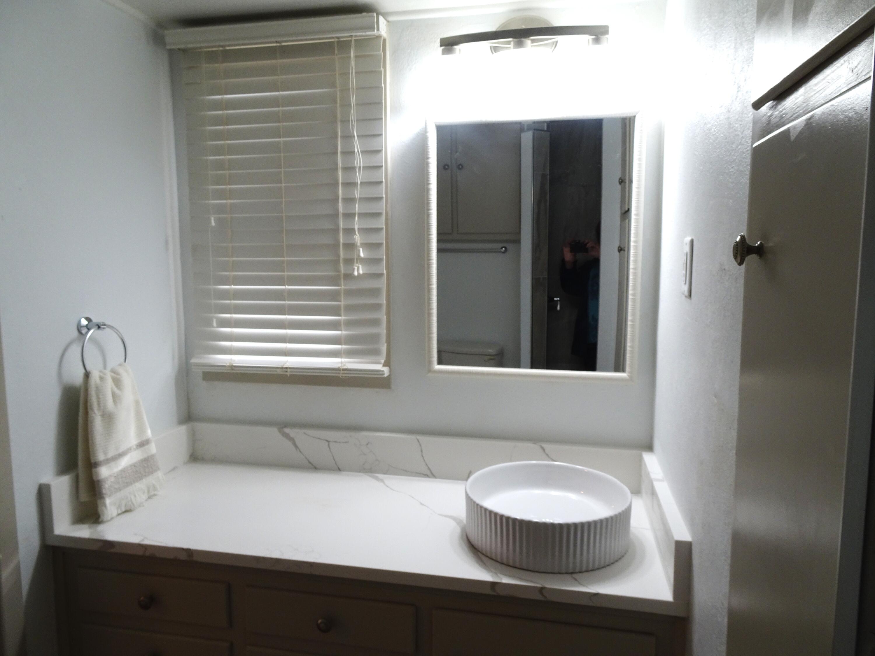 3415 58th Street Lubbock, TX 79413 - Photo 30 of 38 a bathroom with a sink and a mirror