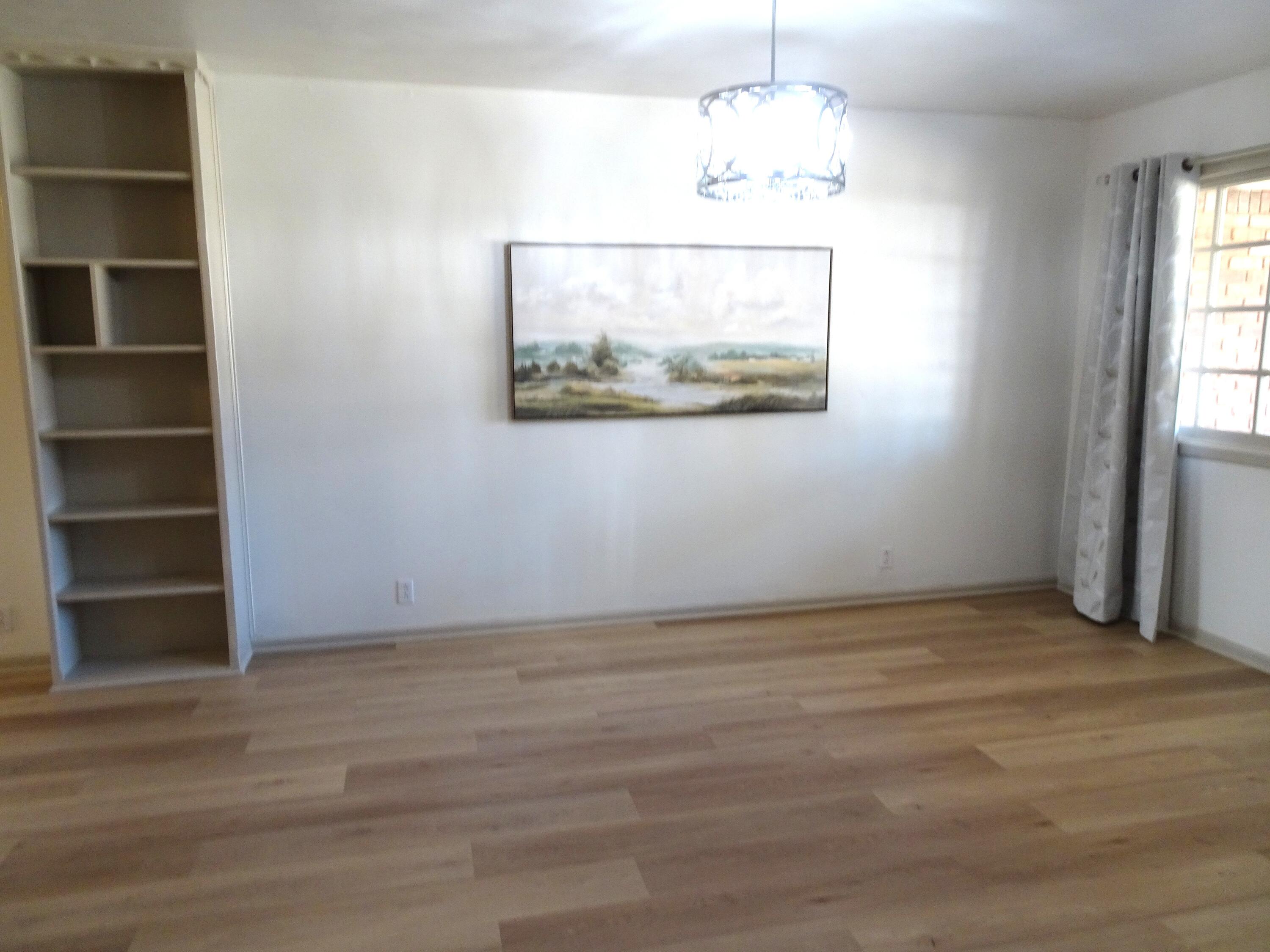 3415 58th Street Lubbock, TX 79413 - Photo 8 of 38 an empty room with wooden floor closet and windows