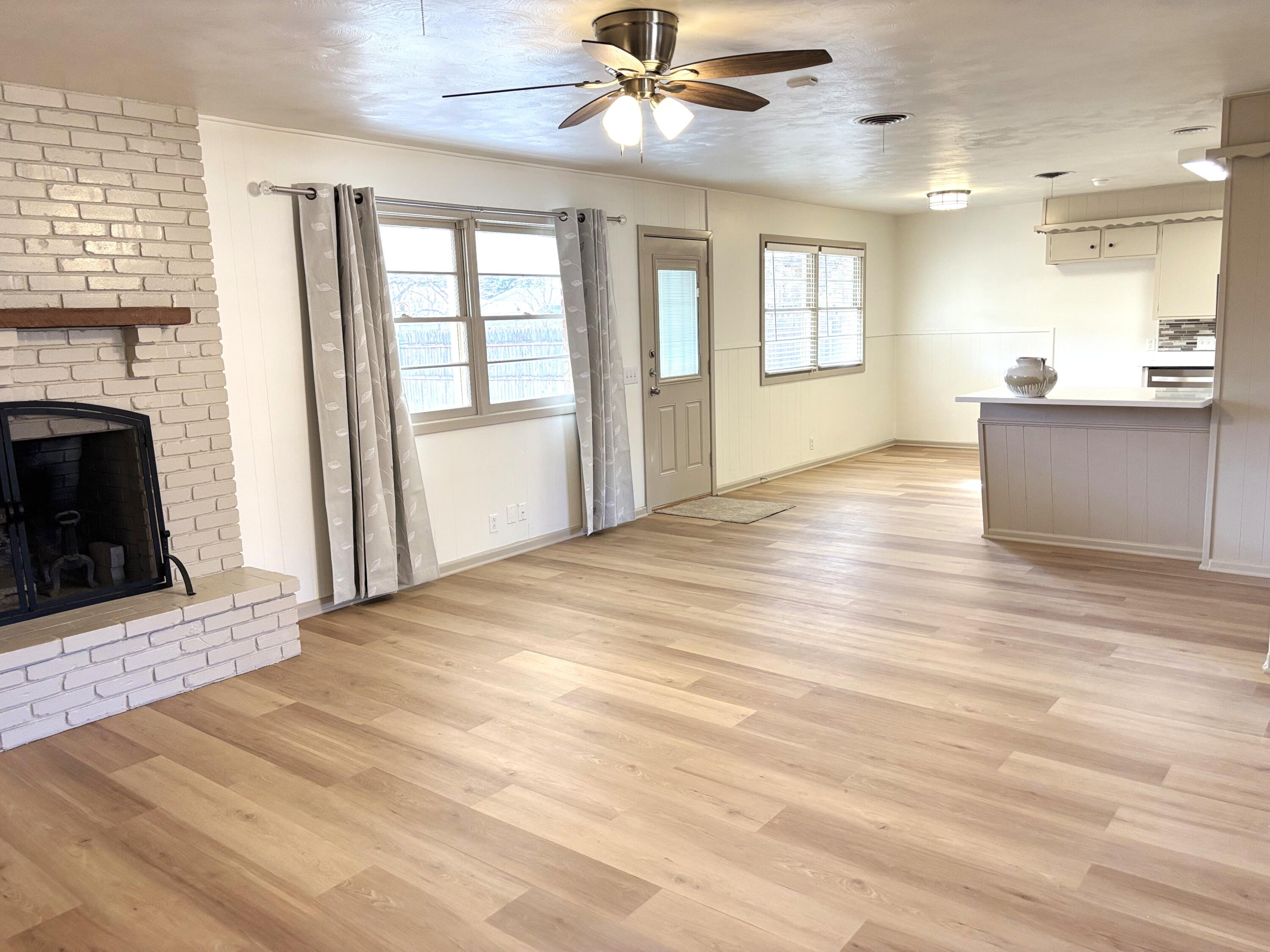 3415 58th Street Lubbock, TX 79413 - Photo 9 of 38 a view of an empty room with a fireplace and a window