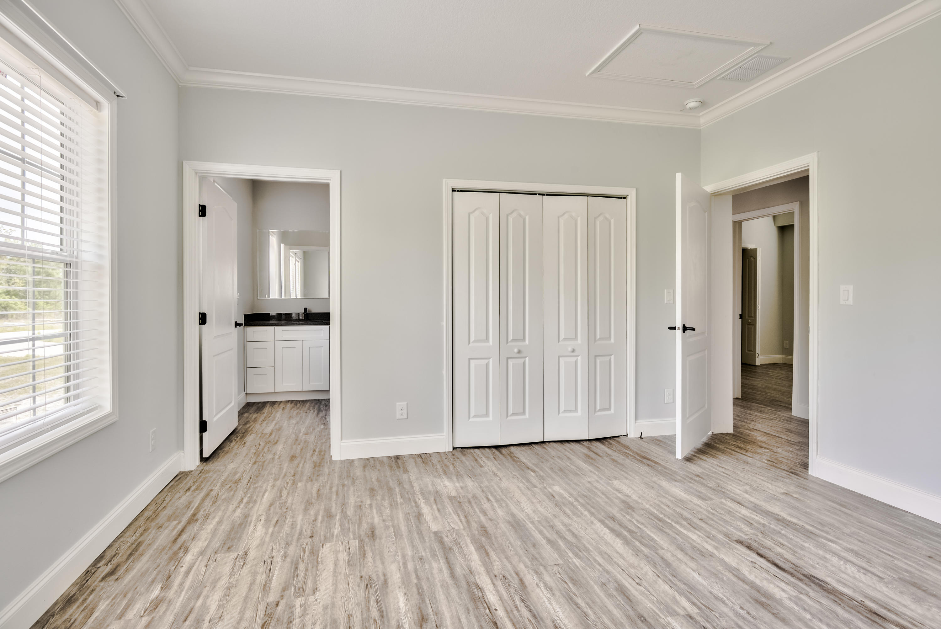 455 North County 395 Santa Rosa Beach, Unit 1 Santa Rosa Beach, FL 32459 - Photo 11 of 13 an empty room with wooden floor & windows