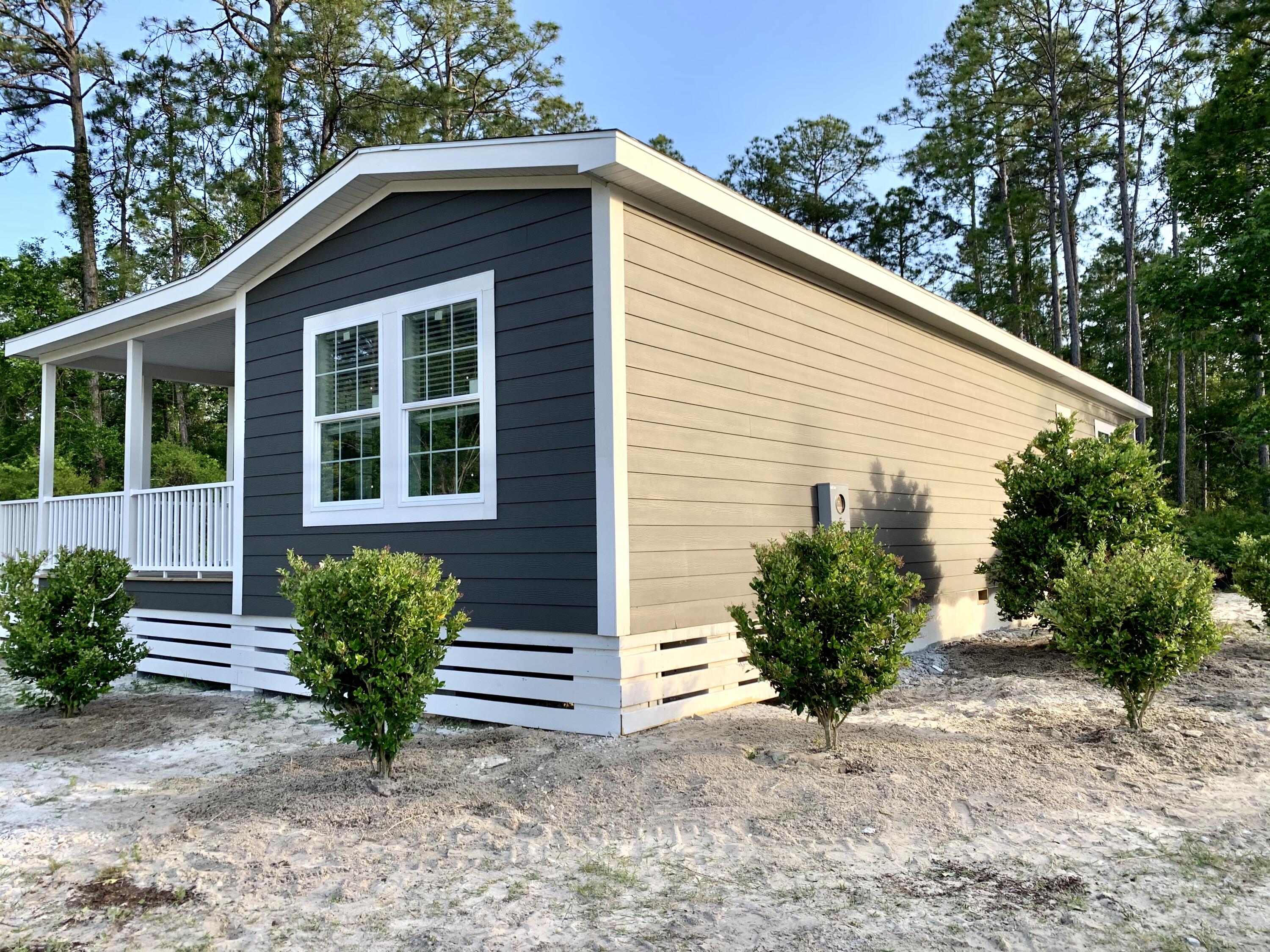 455 North County 395 Santa Rosa Beach, Unit 1 Santa Rosa Beach, FL 32459 - Photo 3 of 13 a view of a house with a yard and plants