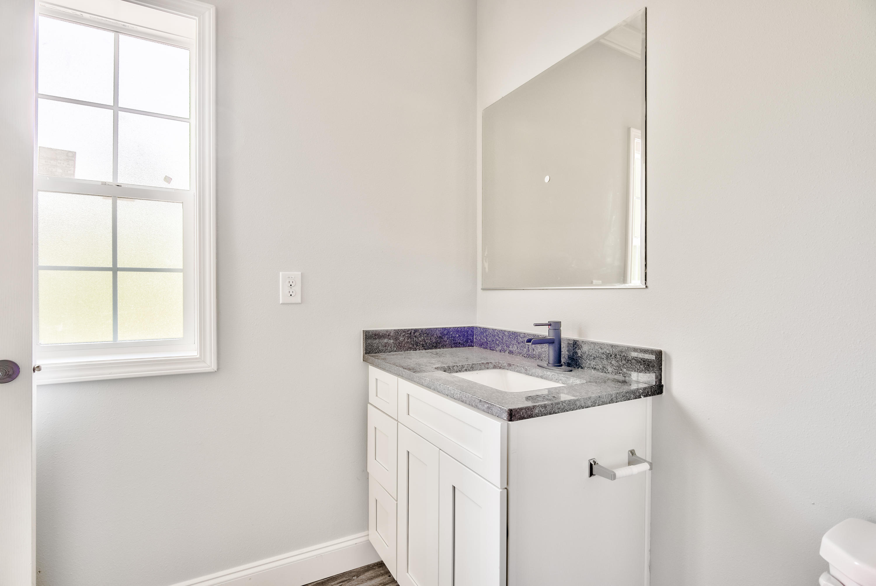 455 North County 395 Santa Rosa Beach, Unit 1 Santa Rosa Beach, FL 32459 - Photo 10 of 13 a bathroom with a granite countertop sink and a window