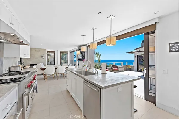 a kitchen with sink stove and cabinets