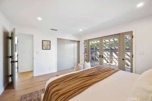 a bedroom with a large bed and a large window