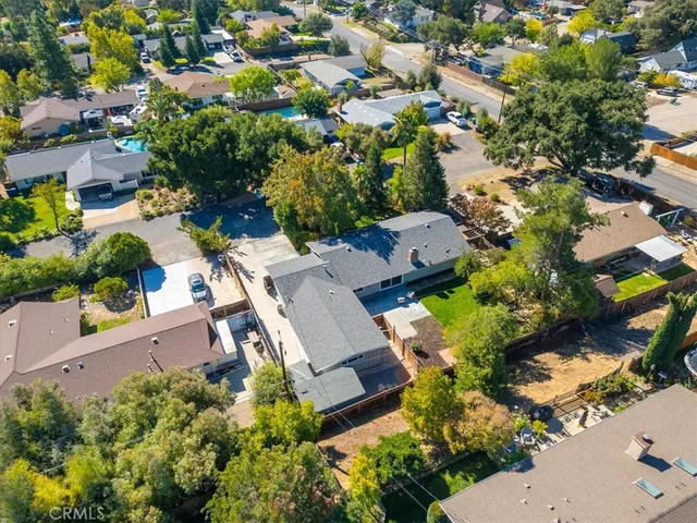 an aerial view of a house with a yard