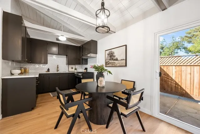 a view of a dining room with furniture a chandelier and wooden floor