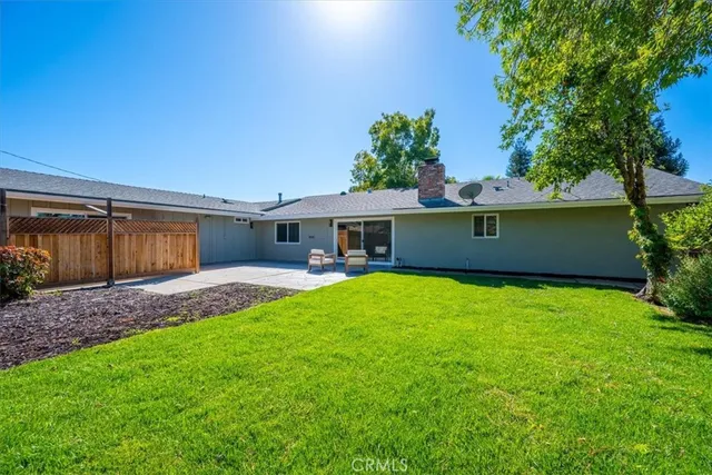 a front view of a house with a garden and yard