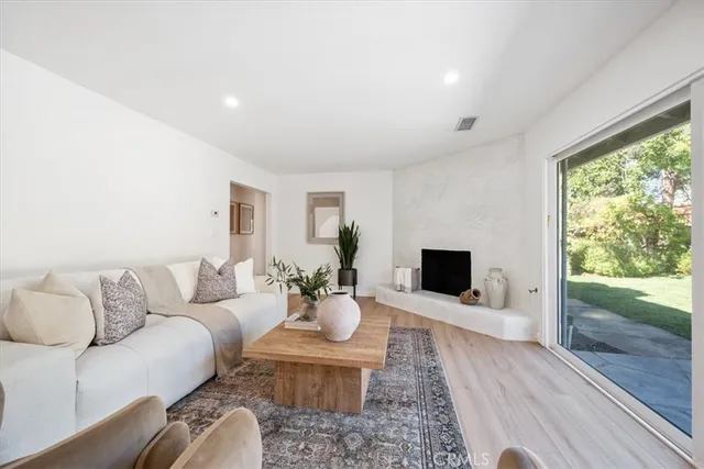 a living room with furniture flat screen tv and a fireplace
