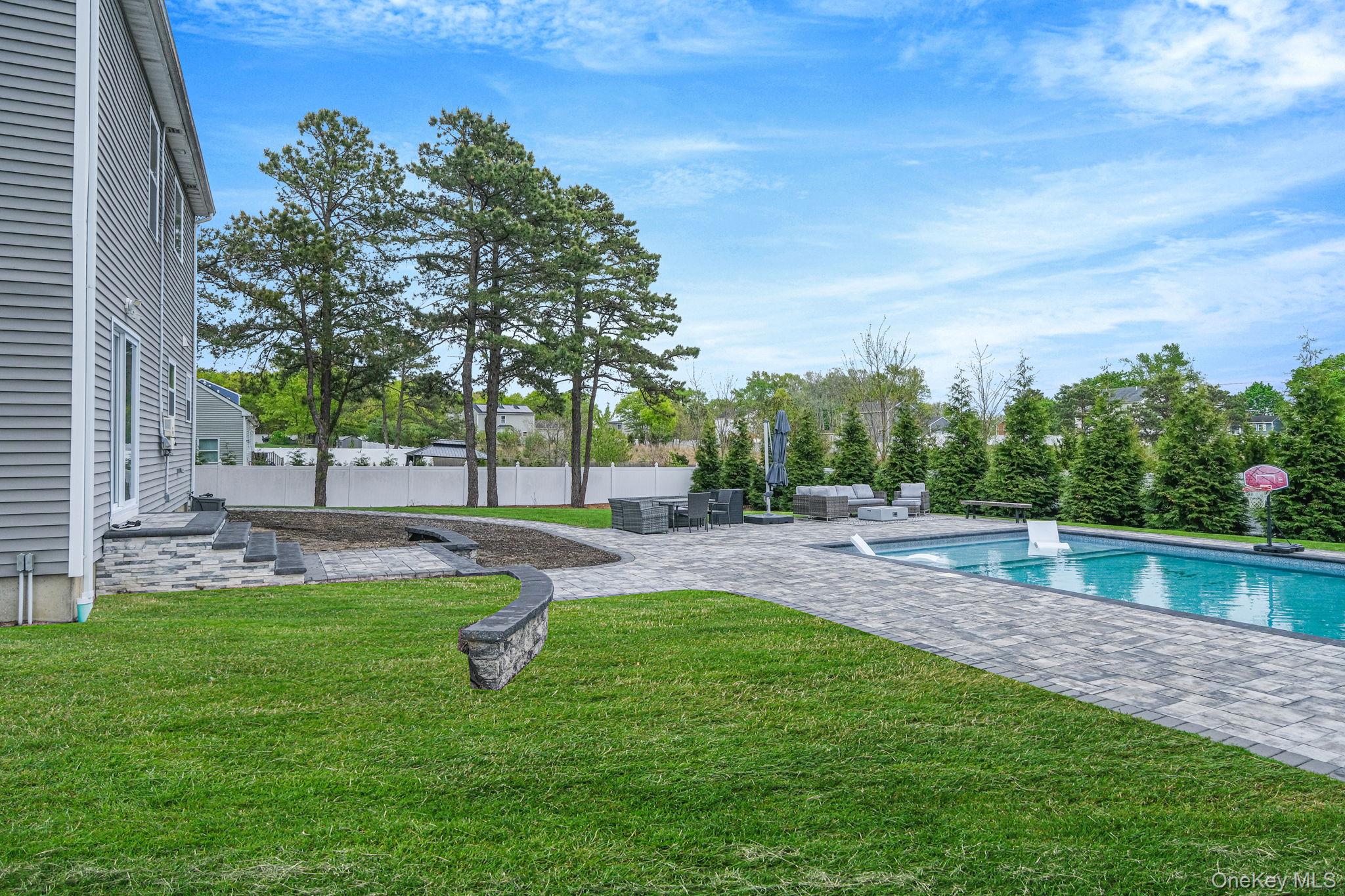 86 Country Road Medford, NY 11763 - Photo 10 of 47 .52 acres with 44’ x 20’ gas-heated Jandy TruGuard mineral in-ground pool with a 10’ sundeck, lounge area, and gorgeous waterfall feature