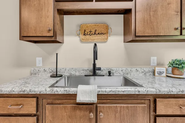 a kitchen with granite countertop a sink and a stove