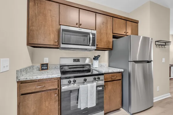 a kitchen with stainless steel appliances granite countertop a refrigerator stove and microwave