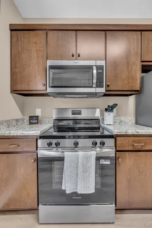 a kitchen with granite countertop a stove and a microwave