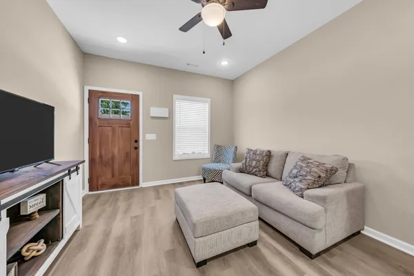 a living room with furniture and a flat screen tv