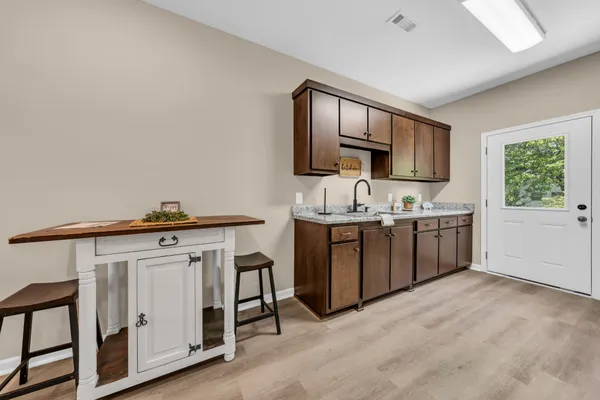 a kitchen with a sink cabinets and window