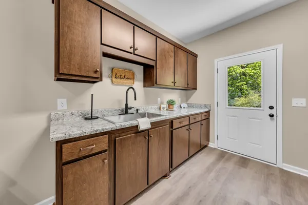 a kitchen with a sink cabinets and window