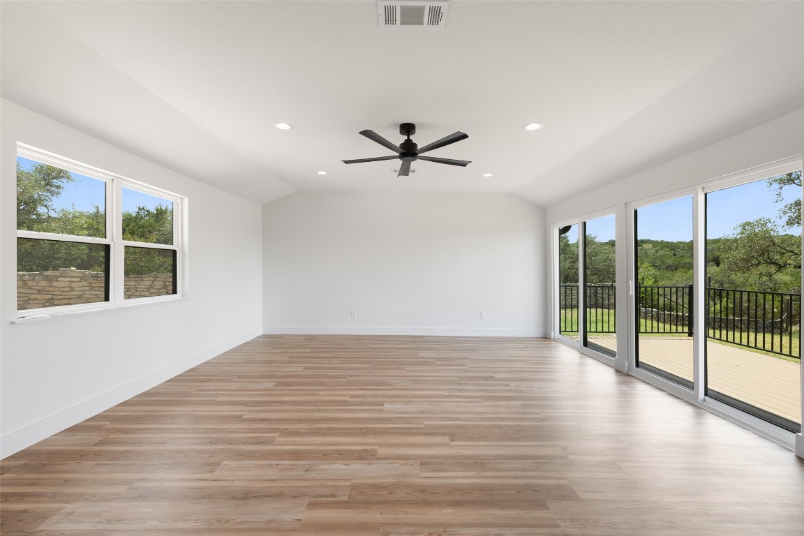 11151 Highway 71 Spicewood, TX 78669 - Photo 5 of 40 Unit A - Living room with expansive sliding glass doors opening to a private outdoor deck.