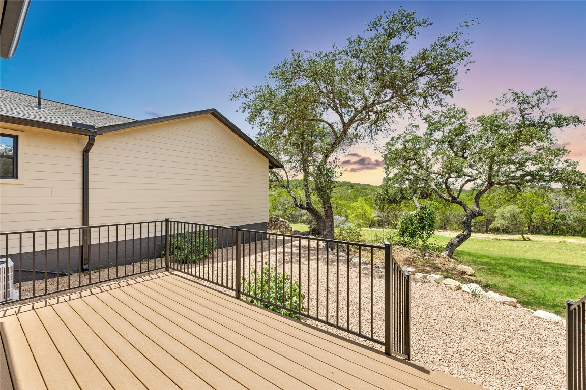 11151 Highway 71 Spicewood, TX 78669 - Photo 7 of 40 Unit A – Private deck at dusk overlooking the backyard courtyard and sweeping Hill Country views.