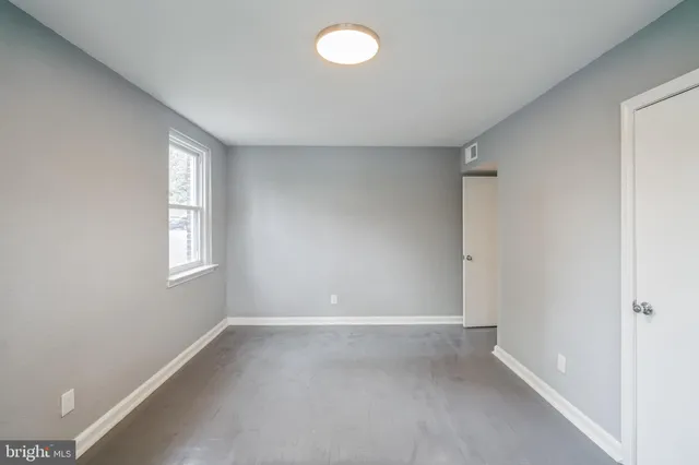 front view of a brick house with a small yard