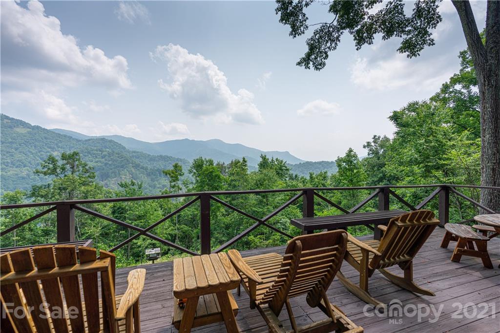 171 Jade Drive Clyde, NC 28721 - Photo 2 of 30 a view of a balcony with chairs and wooden fence