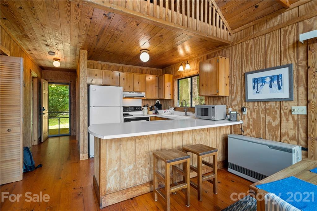 171 Jade Drive Clyde, NC 28721 - Photo 12 of 30 a kitchen with stainless steel appliances granite countertop a sink a stove and a refrigerator