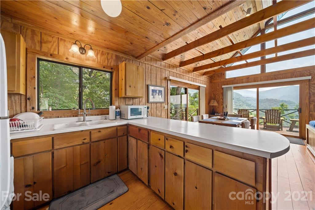 171 Jade Drive Clyde, NC 28721 - Photo 14 of 30 a large kitchen with kitchen island granite countertop a large window