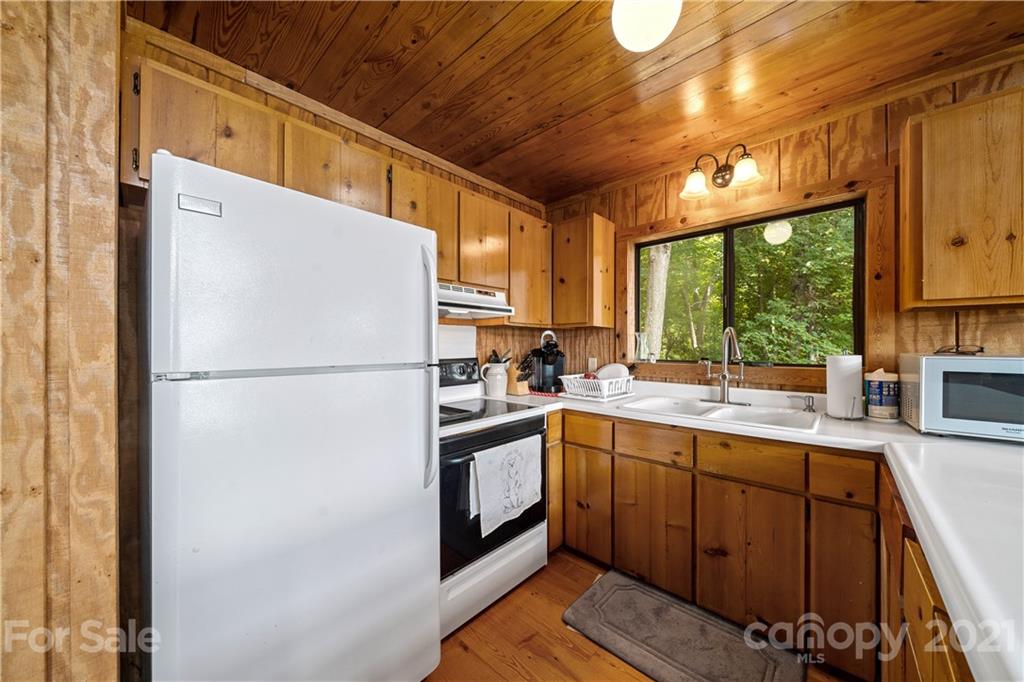 171 Jade Drive Clyde, NC 28721 - Photo 15 of 30 a kitchen with a refrigerator a sink and cabinets