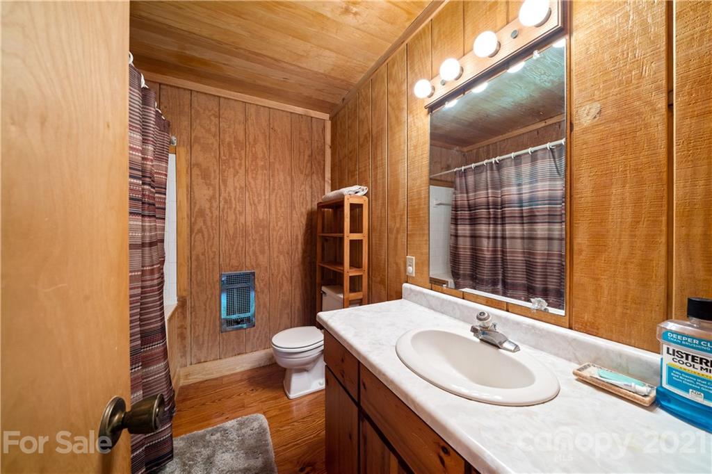 171 Jade Drive Clyde, NC 28721 - Photo 16 of 30 a bathroom with a granite countertop sink toilet and shower