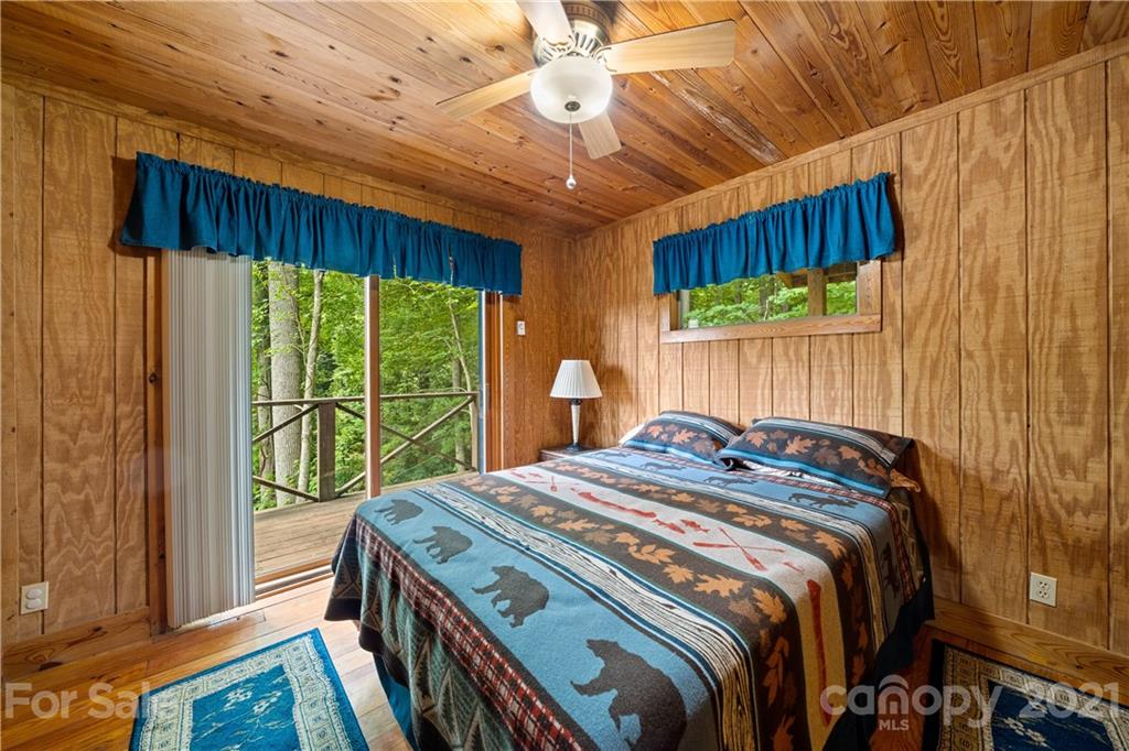 171 Jade Drive Clyde, NC 28721 - Photo 17 of 30 a bed sitting in a bedroom next to a window