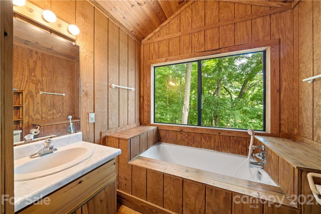 171 Jade Drive Clyde, NC 28721 - Photo 22 of 30 a bathroom with a sink and a large mirror