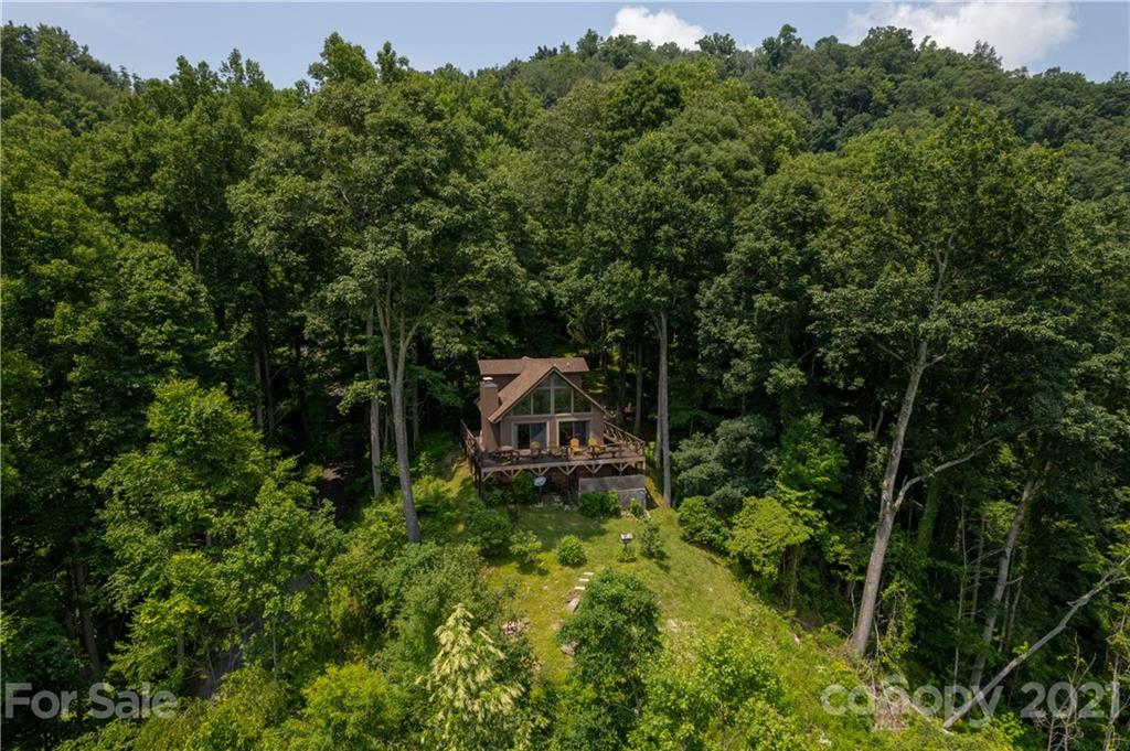 171 Jade Drive Clyde, NC 28721 - Photo 29 of 30 a backyard of a house with table and chairs in the back