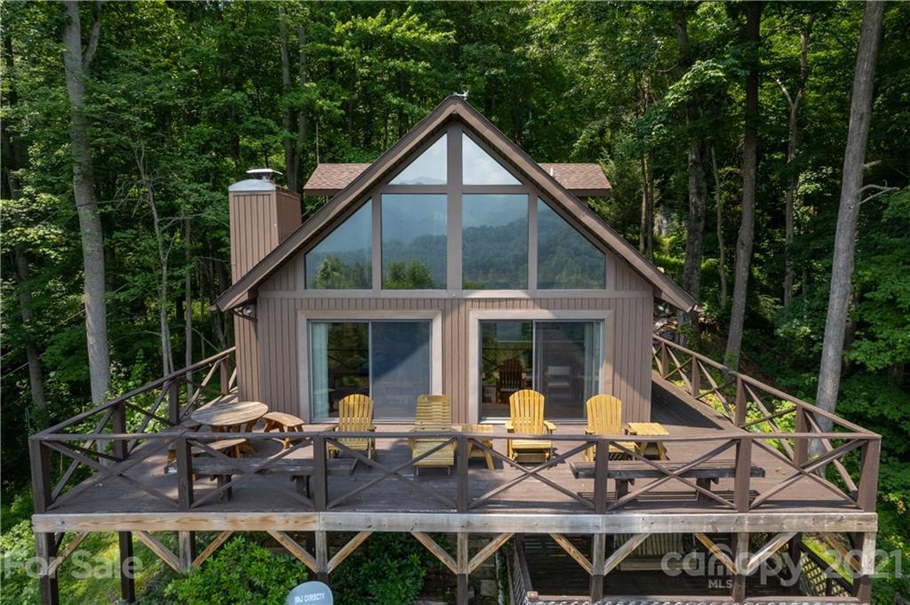 171 Jade Drive Clyde, NC 28721 - Photo 6 of 30 a view of house with wooden deck and outdoor seating