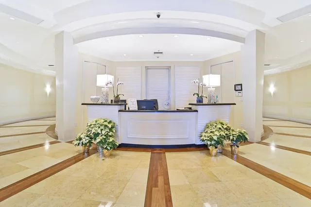 a large white kitchen with a large window and potted plant