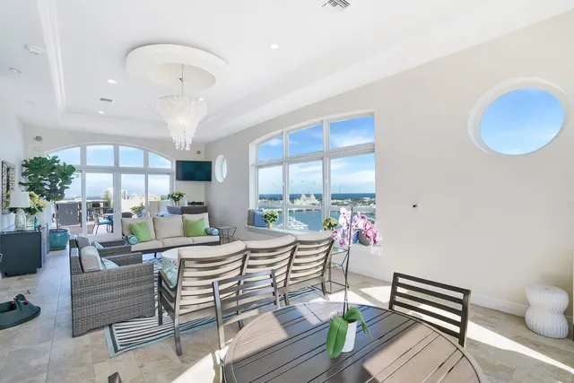 a living room with furniture and a chandelier