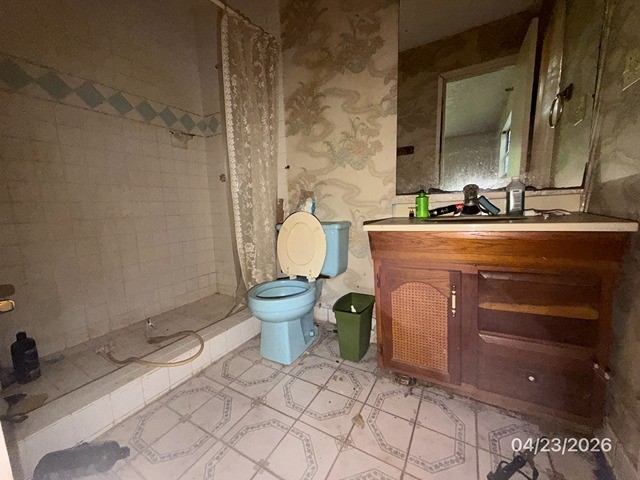 10580 Greenridge Road Conroe, TX 77303 - Photo 9 of 10 a spacious bathroom with a granite countertop sink and a mirror
