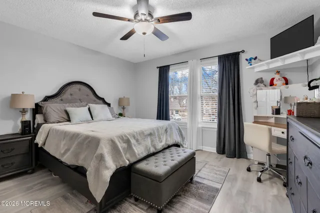 a bedroom with a bed couch and a window