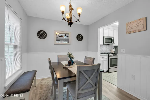 a dining room with wooden floor and breakfast area
