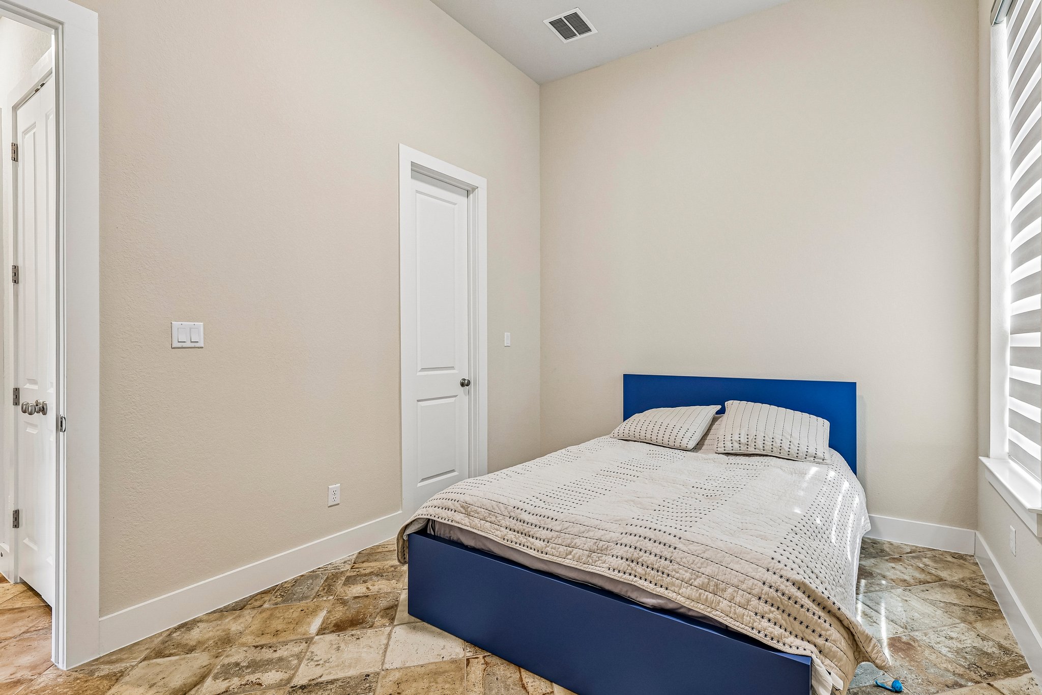 1705 Parten Rnch Parkway Austin, TX 78737 - Photo 12 of 39 A cozy bedroom features high ceilings and patterned tile flooring.