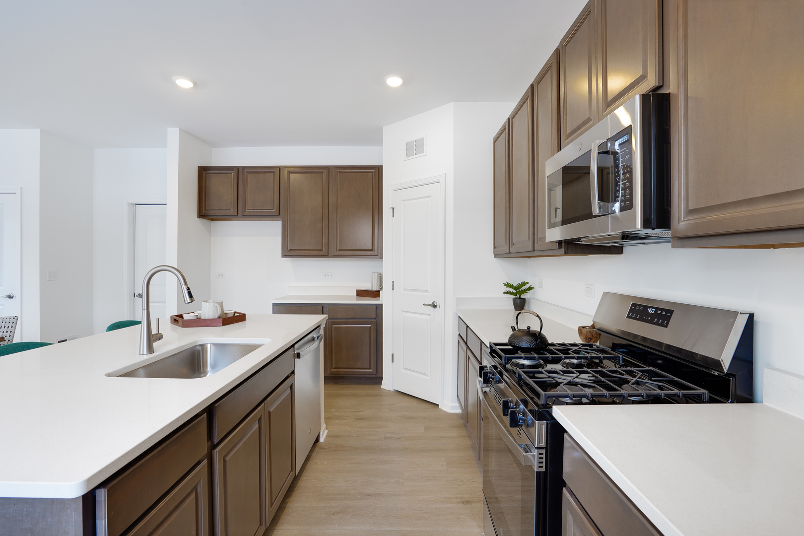 586 Lismore Circle Elgin, IL 60124 - Photo 2 of 35 a kitchen with stainless steel appliances a sink a stove top oven a counter space and cabinets