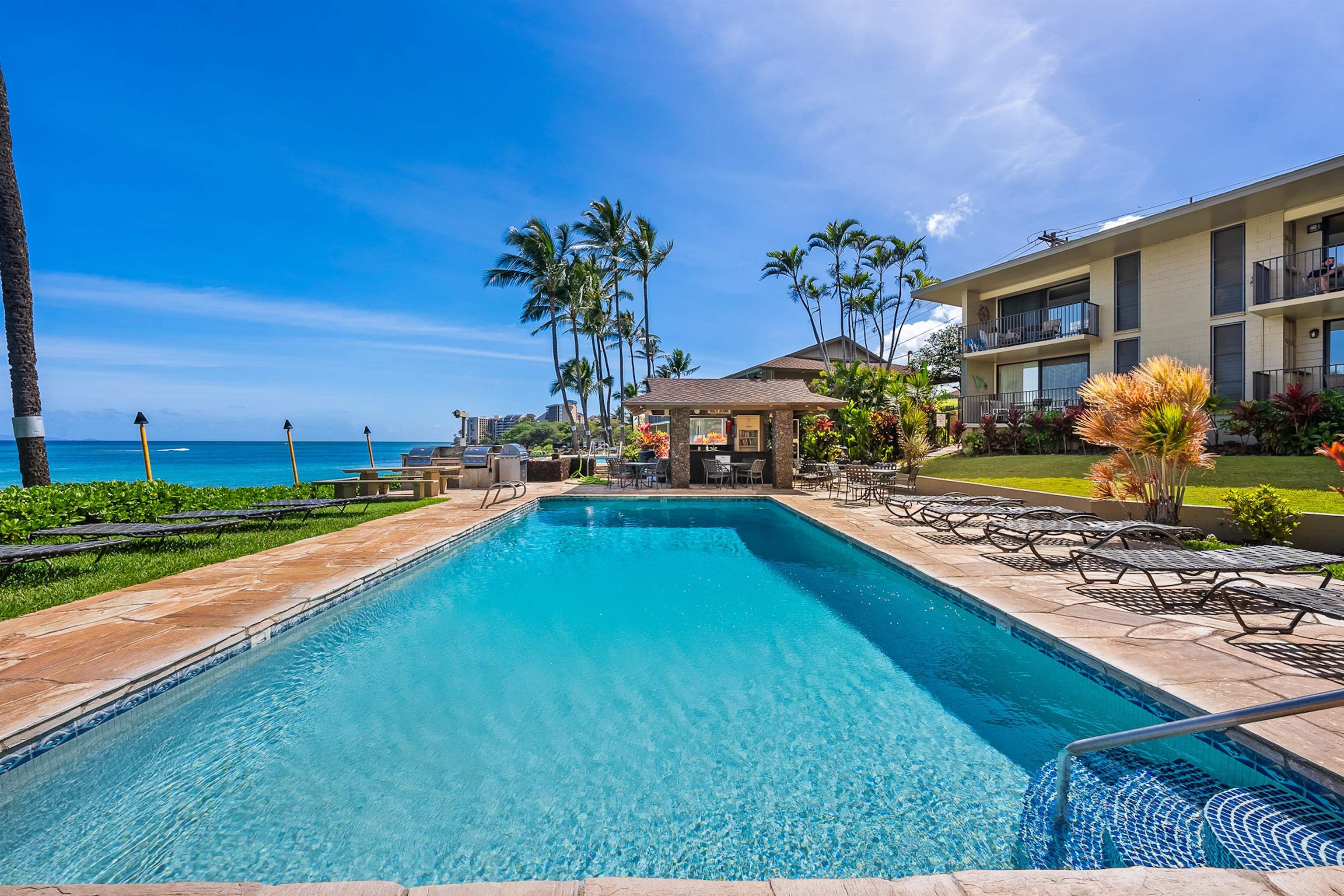 4095 Lower Honoapiilani Road, Unit 114B Lahaina, HI 96761 - Photo 13 of 18 a swimming pool with outdoor seating and yard