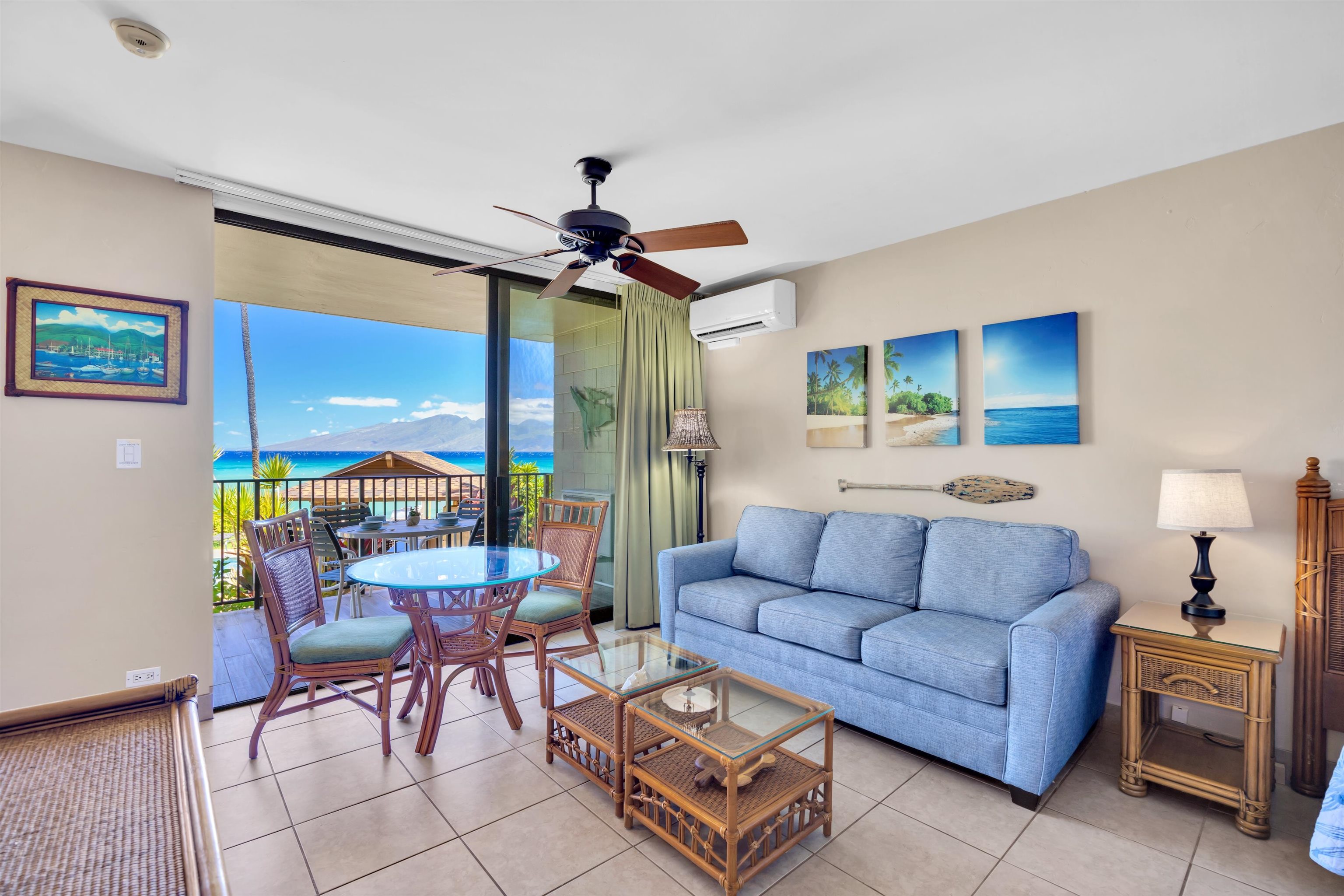 4095 Lower Honoapiilani Road, Unit 114B Lahaina, HI 96761 - Photo 2 of 18 a living room with furniture a ceiling fan and a large window