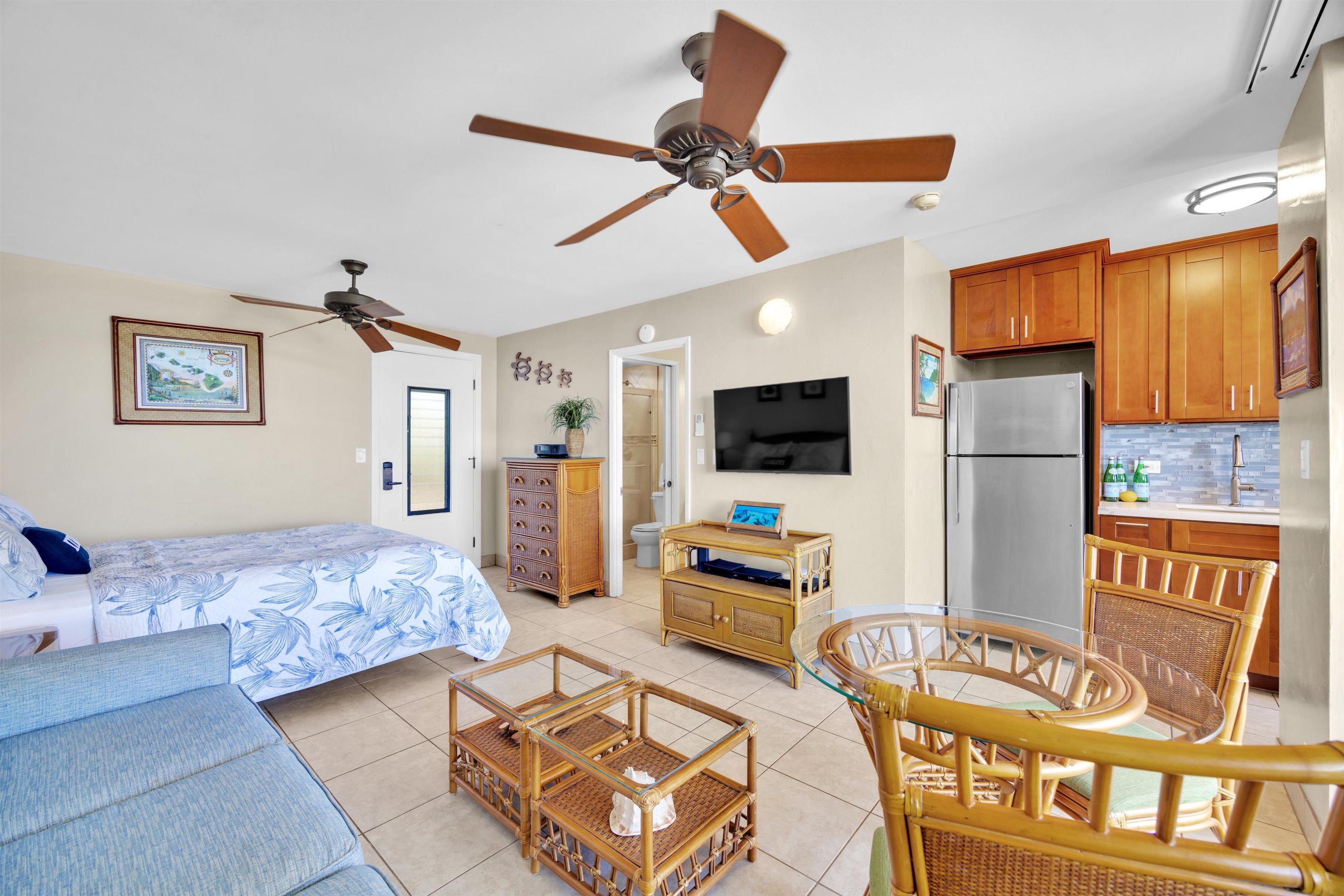 4095 Lower Honoapiilani Road, Unit 114B Lahaina, HI 96761 - Photo 3 of 18 a bedroom with furniture and a flat screen tv
