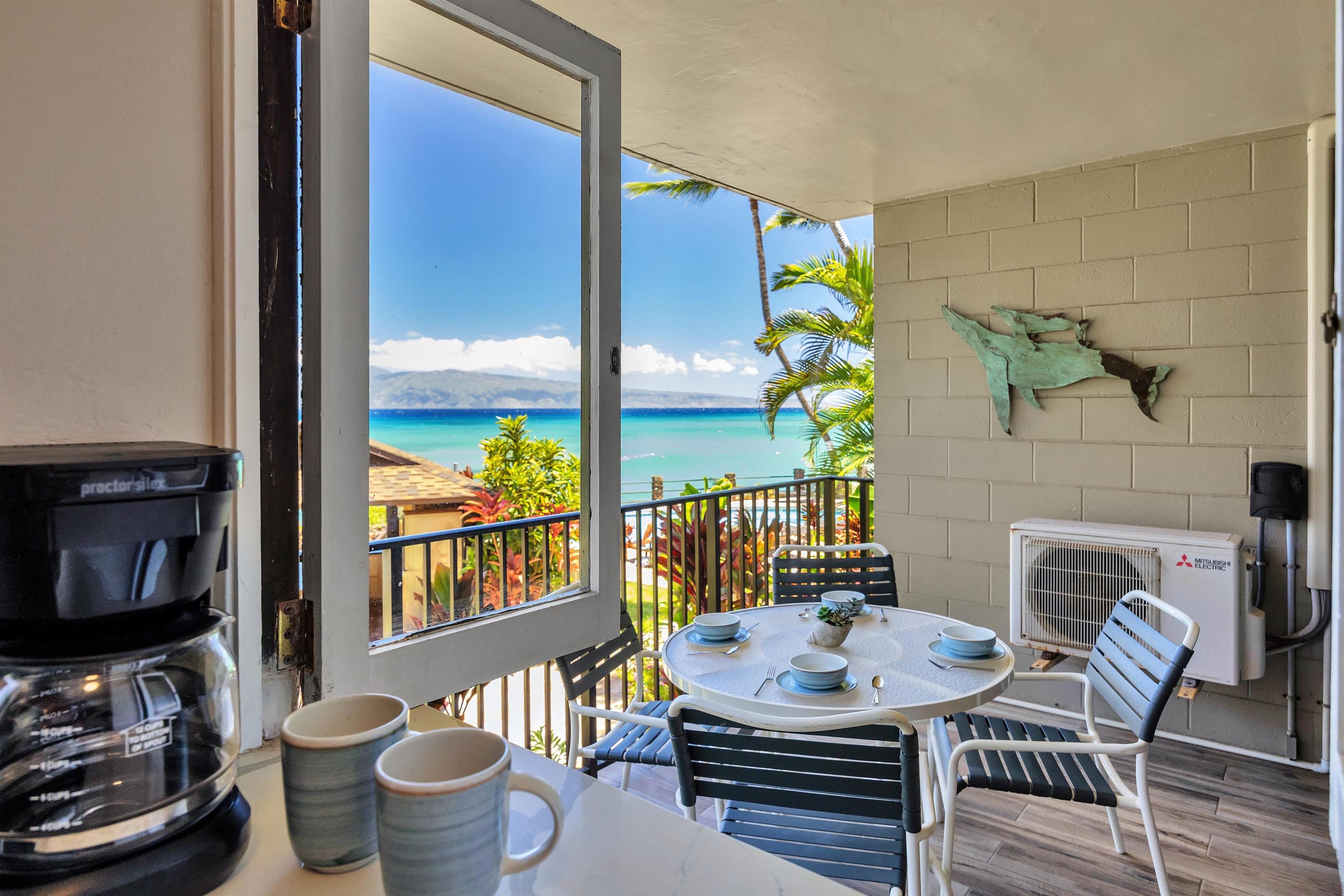 4095 Lower Honoapiilani Road, Unit 114B Lahaina, HI 96761 - Photo 6 of 18 a dining room with furniture a fireplace and a potted plants