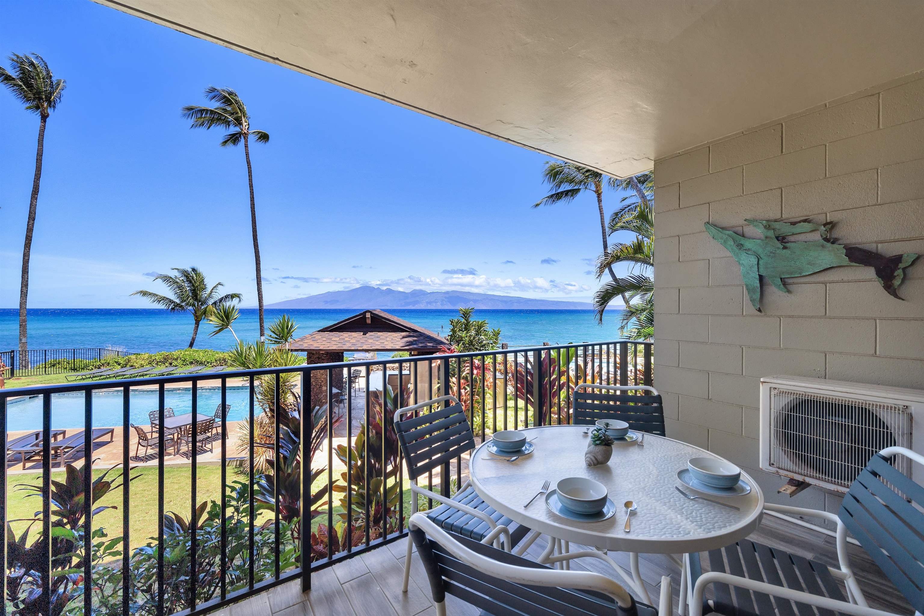 4095 Lower Honoapiilani Road, Unit 114B Lahaina, HI 96761 - Photo 9 of 18 a table and chairs in a balcony