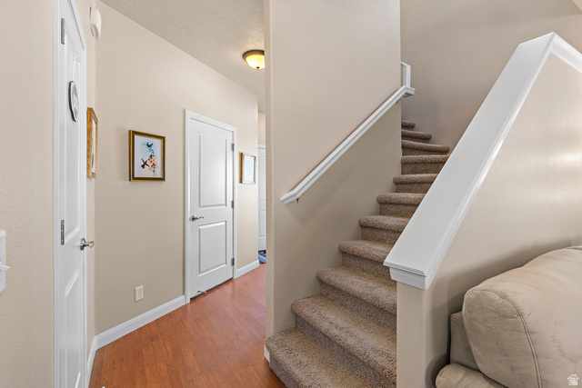2484 Manzoni Road Santa Clara, UT 84765 - Photo 16 of 27 Staircase featuring wood finished floors and baseboards