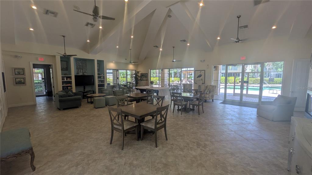 6552 Moorings Point Circle, Unit 102 Lakewood Ranch, FL 34202 - Photo 44 of 57 a dining room with furniture and wooden floor