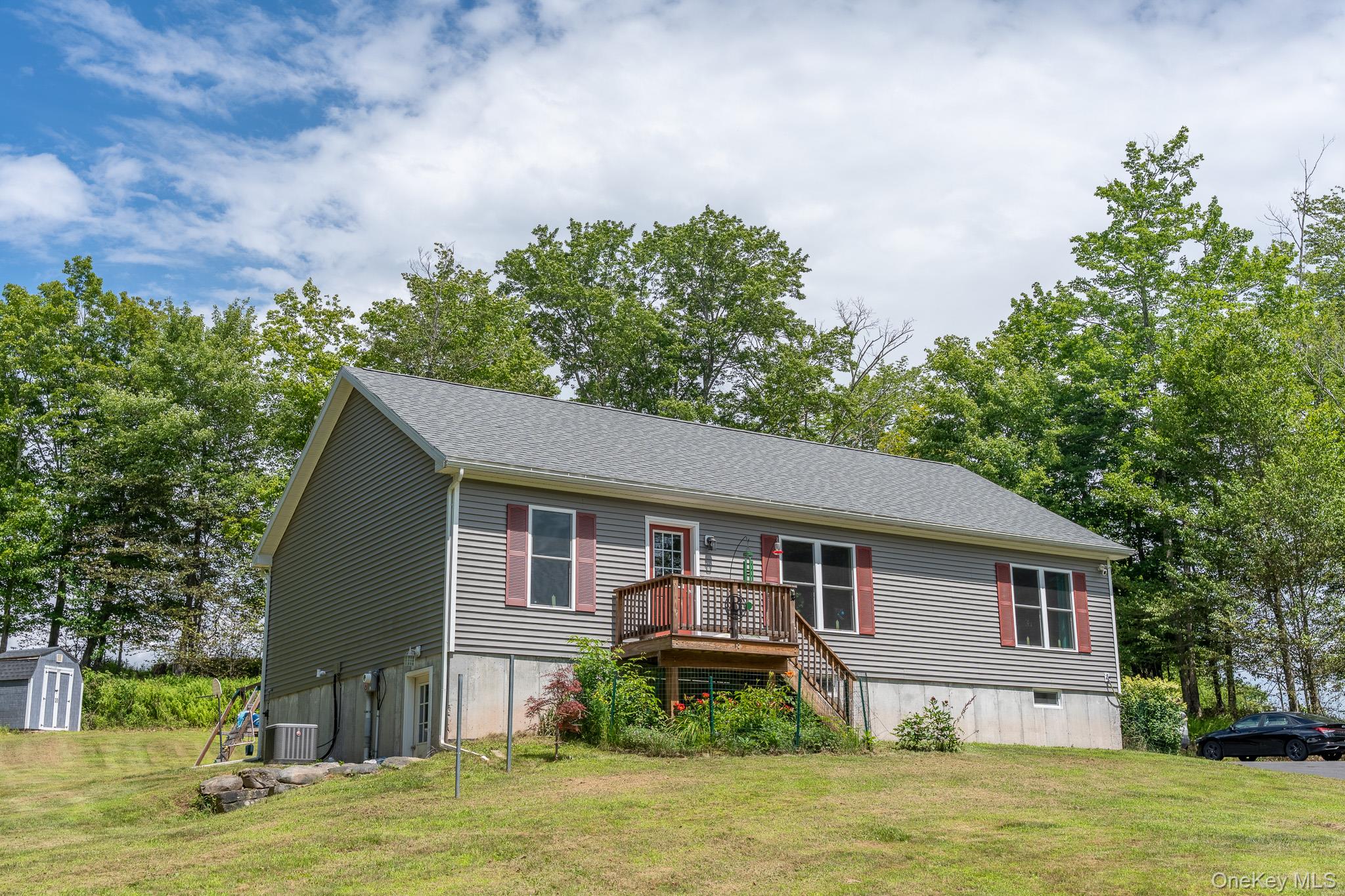 a front view of house with yard and green space