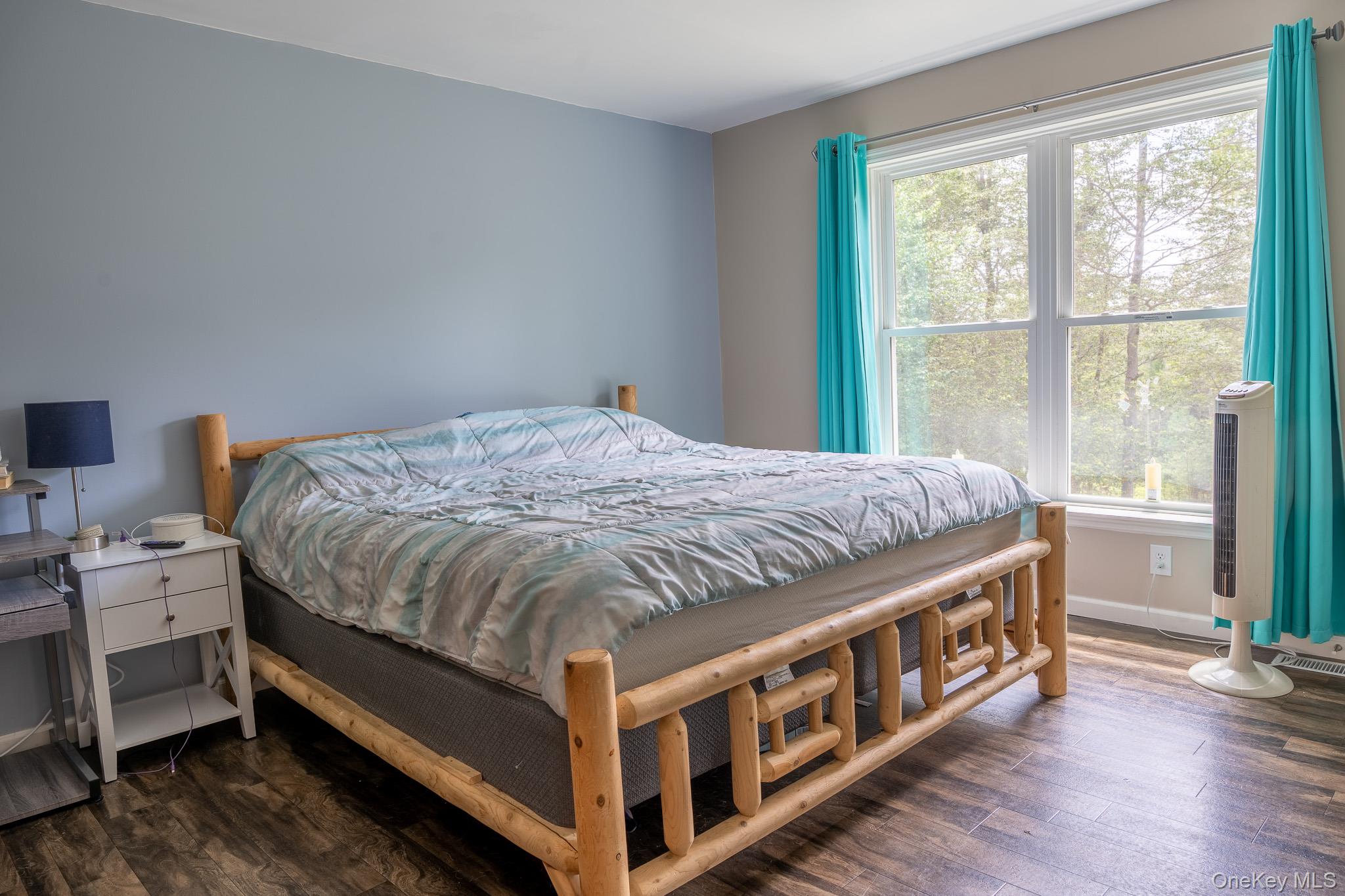 56 Ahrens Road Parksville, NY 12768 - Photo 13 of 23 a bed sitting in a bedroom next to a window